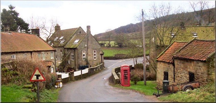 Low Mill from the car park, across the West Gill Beck road bridge, to the road junction where the route turns left