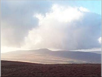 The distant shape of Inglebrough seen from Pen-y-ghent