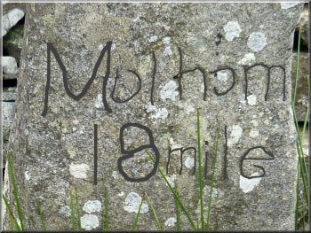 The worn inscription reads Malham 18 mile 