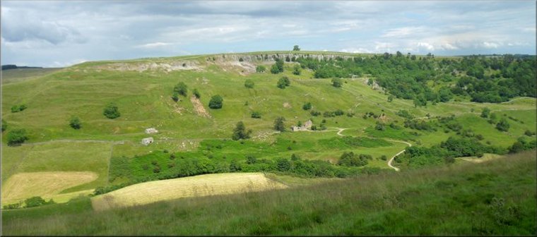 The limestone cliffs of Clints Scar above Orgate Farm seen from the track across Skelton Moor