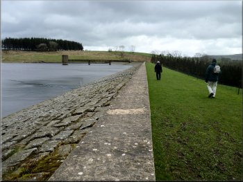 Walking along the crest of the dam at Stocks Reservoir