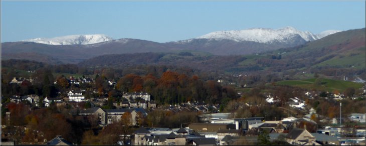 Snow on the distant Lakeland Fells looking North West from Castle Hill