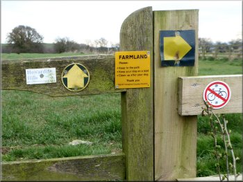 An array of signs on the stile at Well Lane