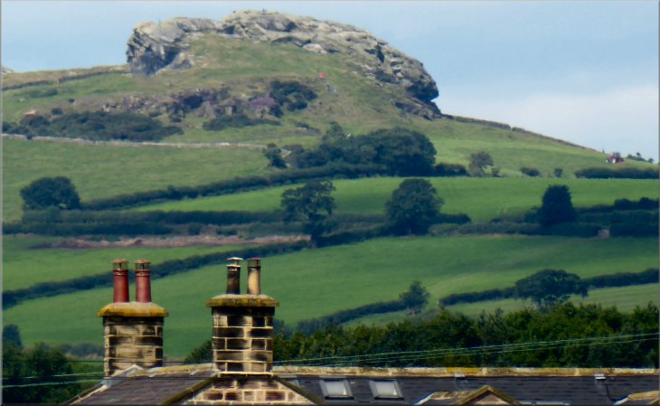 Looking west, from the fields below Kirkby Overblow, over the roofs of Swindon Hall to Almscliff Crag
