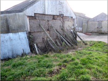 Straw stack shored up by Thornton Lane