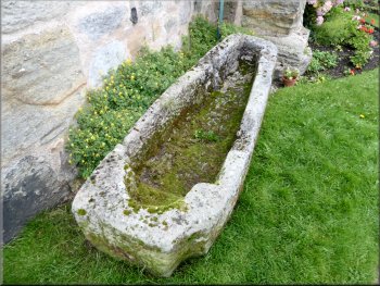 Stone coffin at the corner of the church