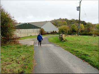 Dropping down past the farm buildings