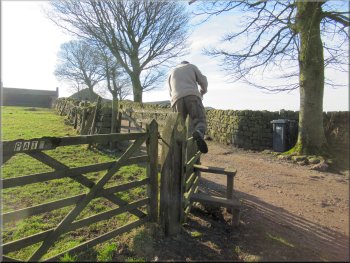 Stile into the field at the start of the farm access track