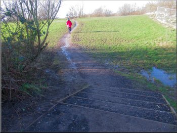 Path from the bridge to the gravel path around the lakeside