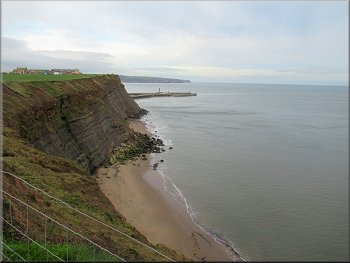 Looking back along the coast to the arms of Whitby Harbour
