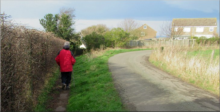 Following the public footpath straight on where the lane bends to our right