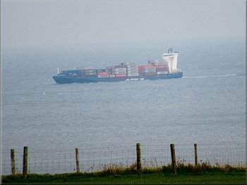 Container ship heading north along the coast