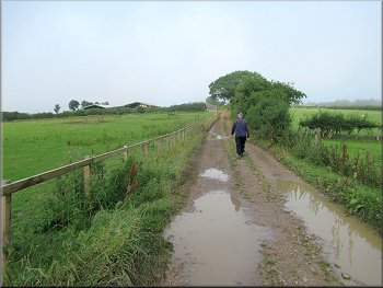 Footpath along the farm track to more farm buildings